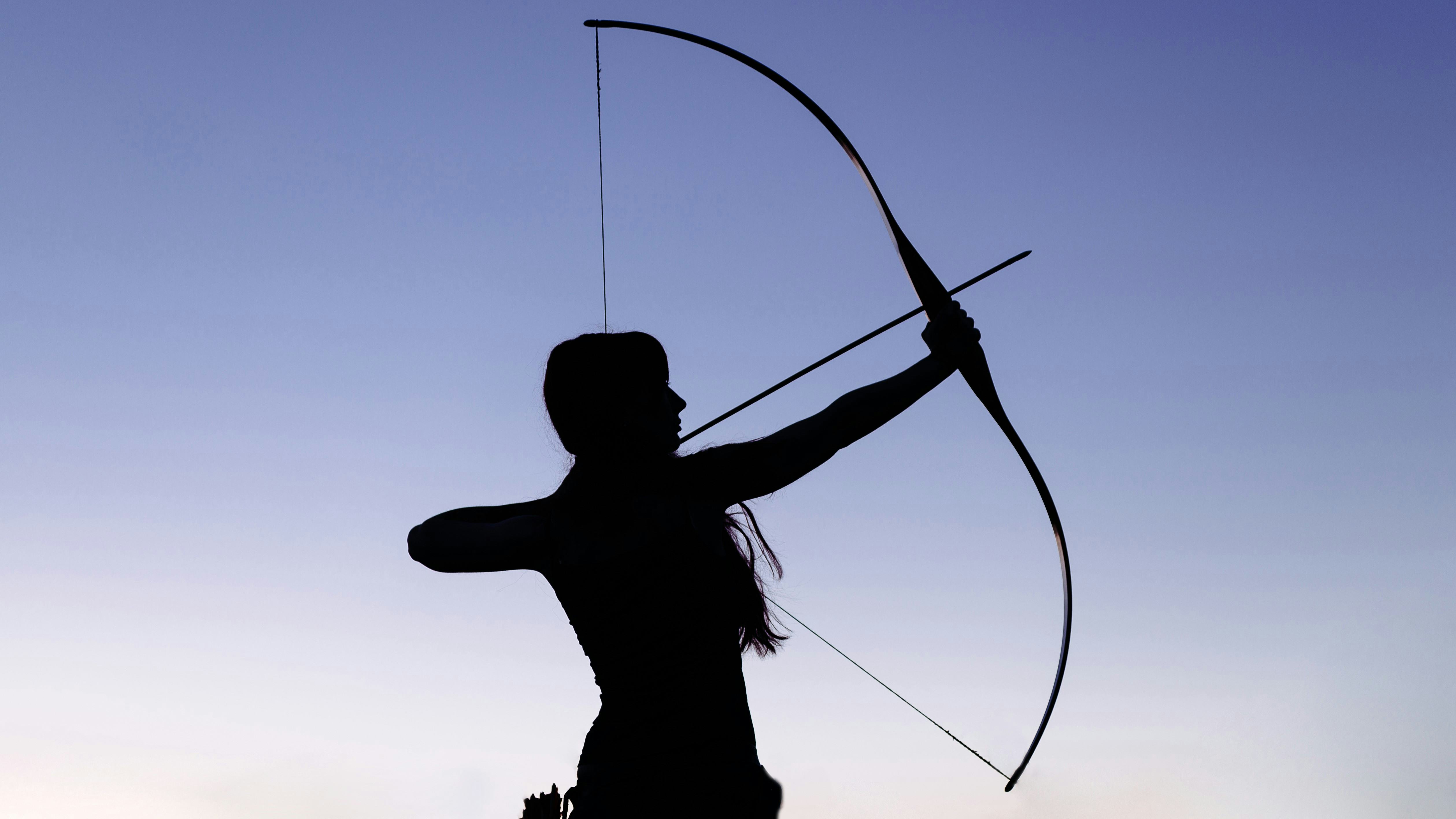 Silhouette of a female archer